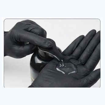 Squeezing the shampoo into a gloved hand