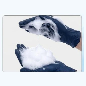 Rubbing the shampoo between gloved hands to build a lather